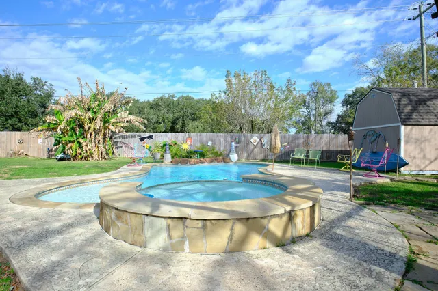 a view of a swimming pool with a patio