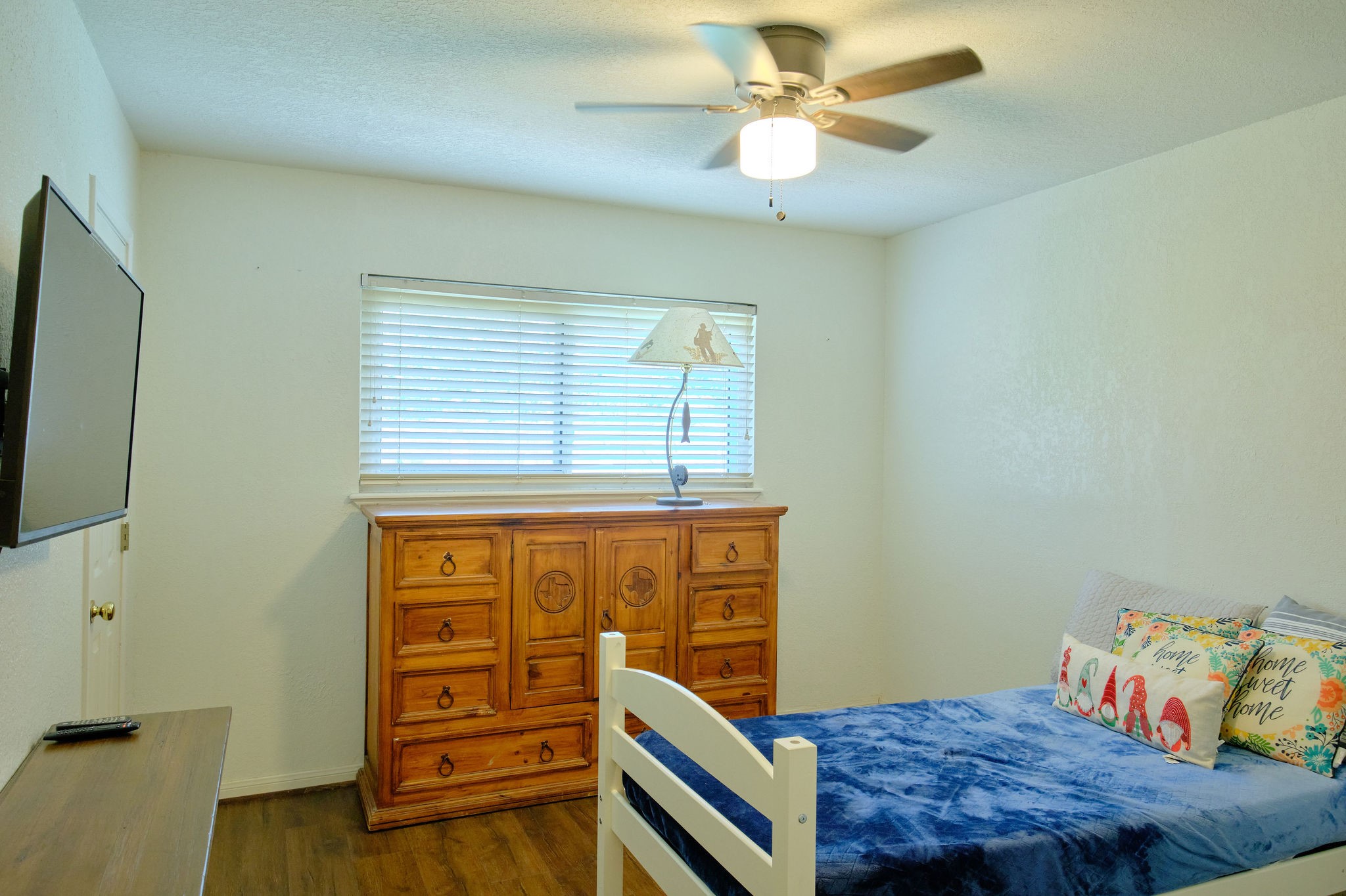 729 Newman Street Angleton, TX 77515 - Photo 16 of 24 a bedroom with a bed and a chandelier