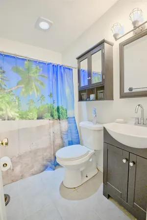 a bathroom with a sink a toilet and mirror