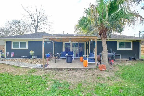 a front view of house with yard and barbeque oven