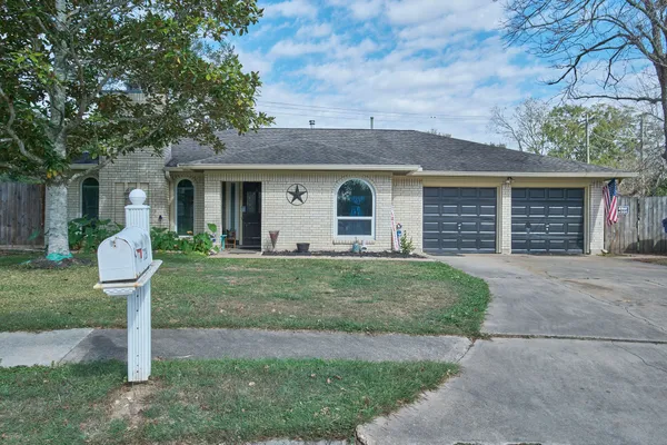 a front view of a house with a garden and yard