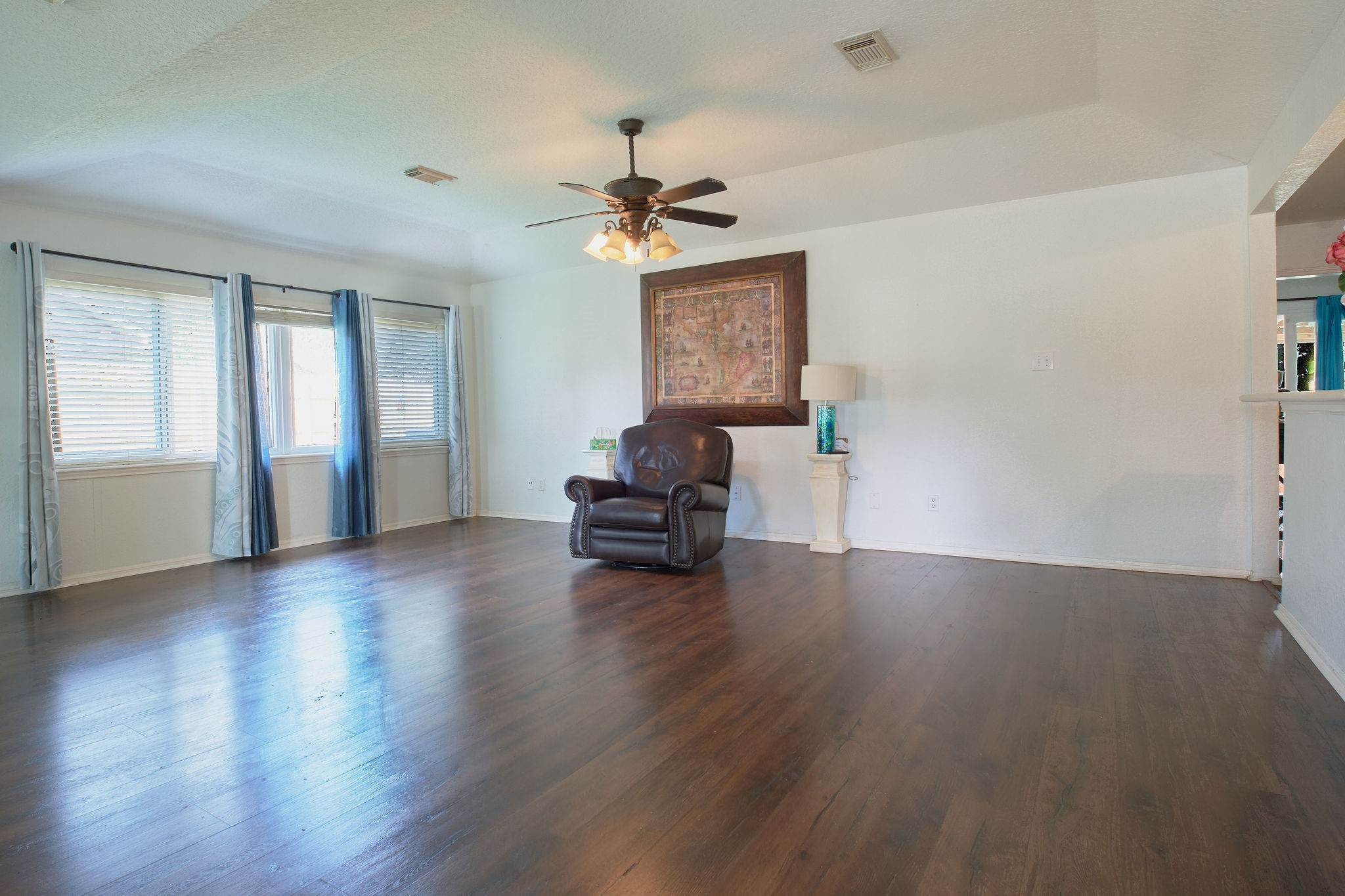 729 Newman Street Angleton, TX 77515 - Photo 5 of 24 a view of empty room with wooden floor and fan