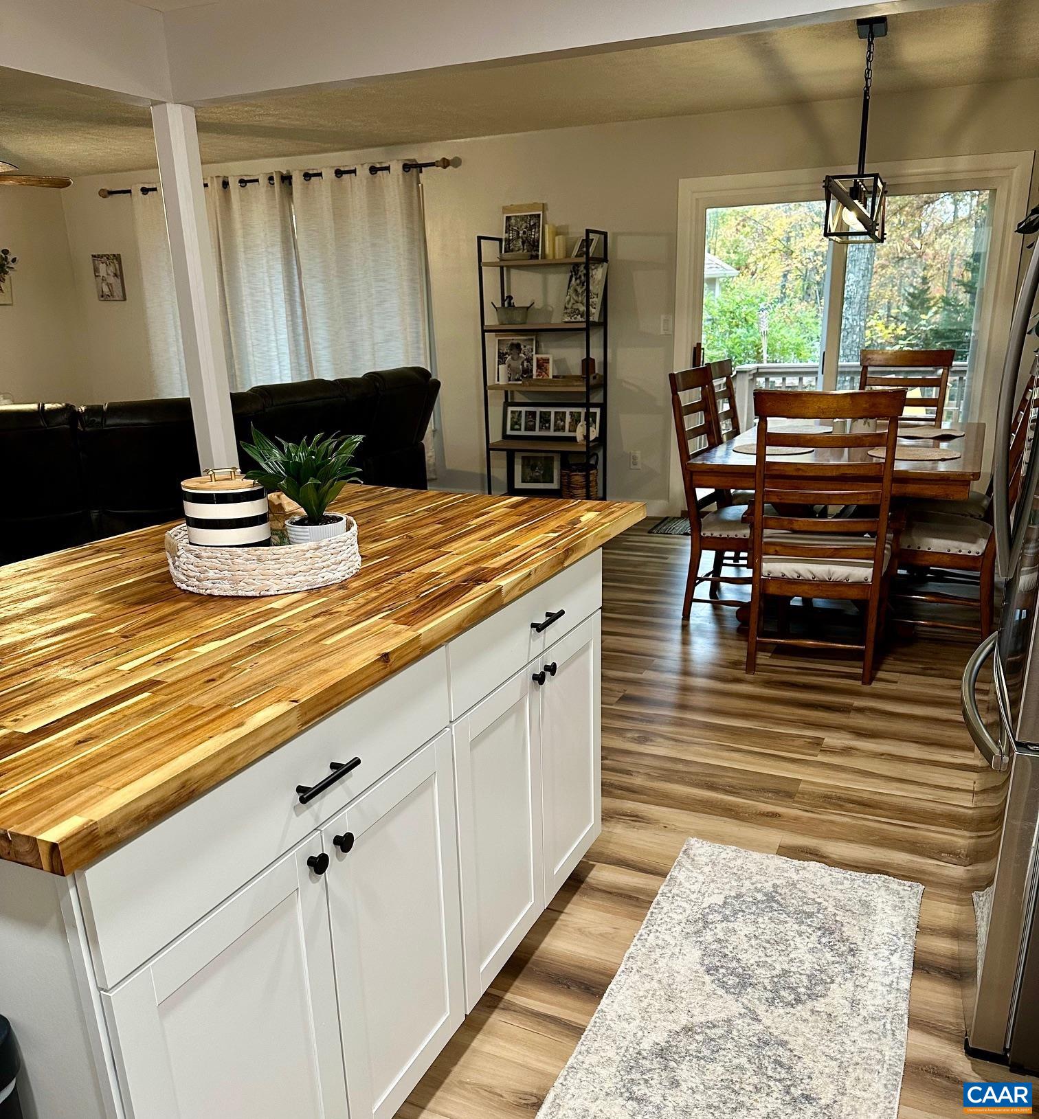 12 Highland Road Palmyra, VA 22963 - Photo 8 of 41 a kitchen with stainless steel appliances kitchen island granite countertop a table chairs and a wooden floor