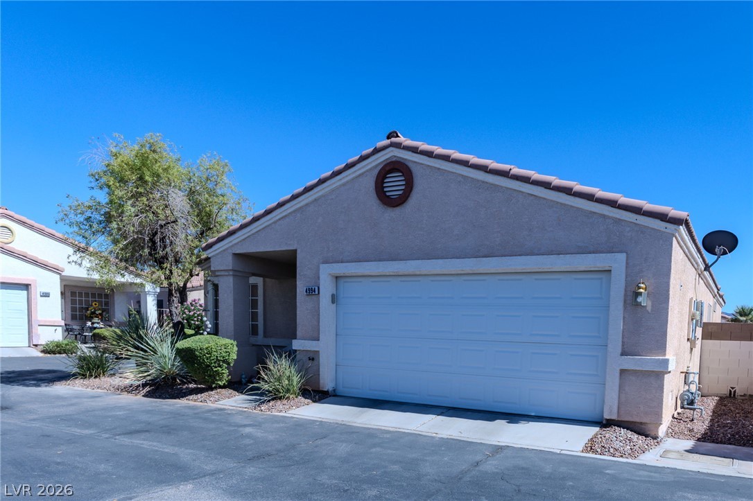 4994 Mascaro Drive Las Vegas, NV 89122 - Photo 30 of 30 A well-maintained stucco exterior offers a welcoming impression with a two-car garage.