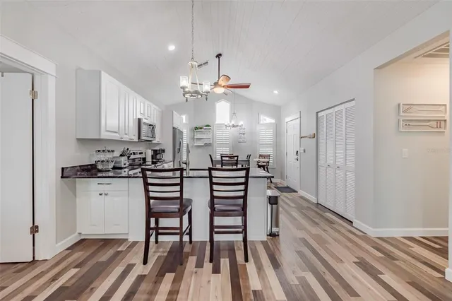 a kitchen with a refrigerator and a sink