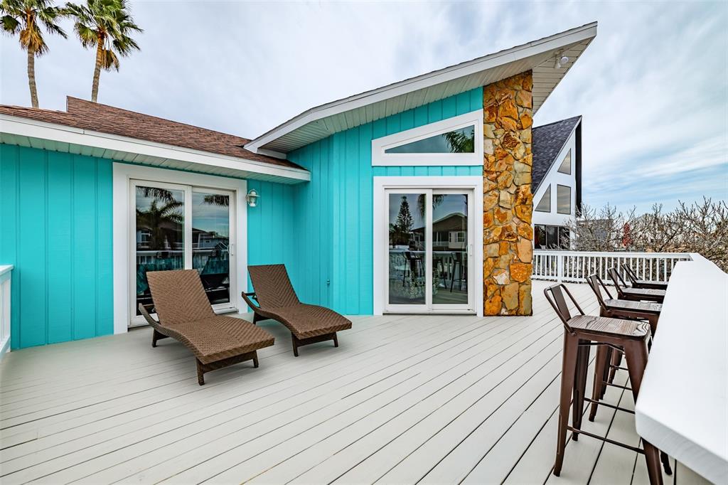 4021 Casa Court Hernando Beach, FL 34607 - Photo 2 of 37 a balcony with furniture and a potted plant