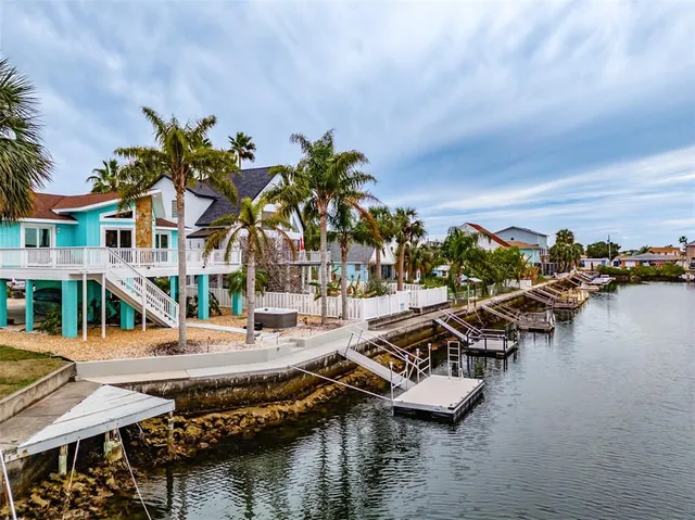a view of houses with swimming pool and outdoor seating