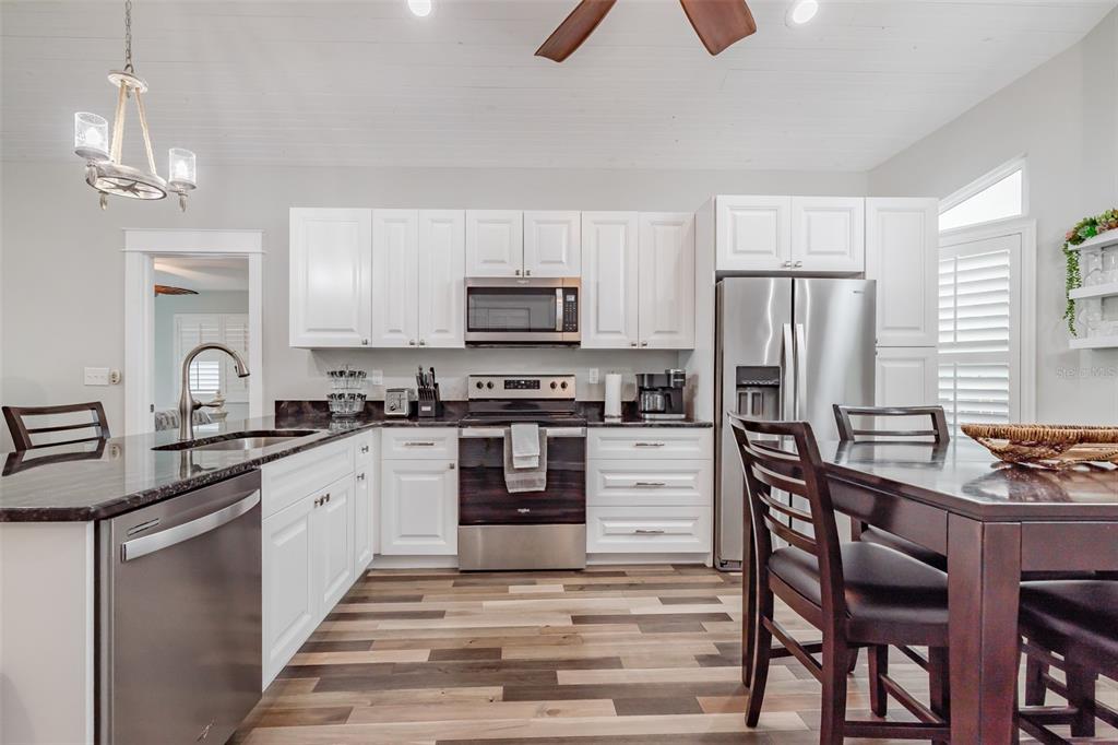 4021 Casa Court Hernando Beach, FL 34607 - Photo 34 of 37 a kitchen with granite countertop a refrigerator stove top oven and sink