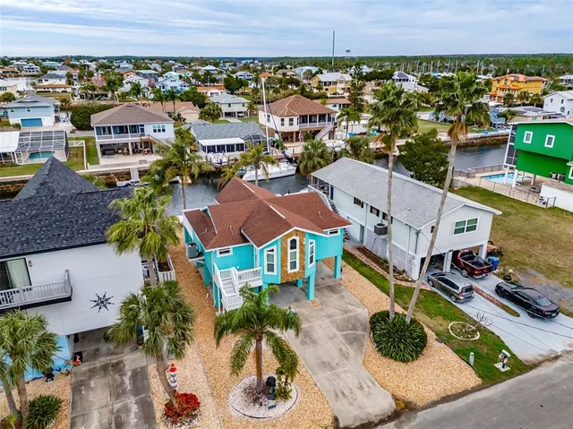 an aerial view of a house with a swimming pool a yard and outdoor seating