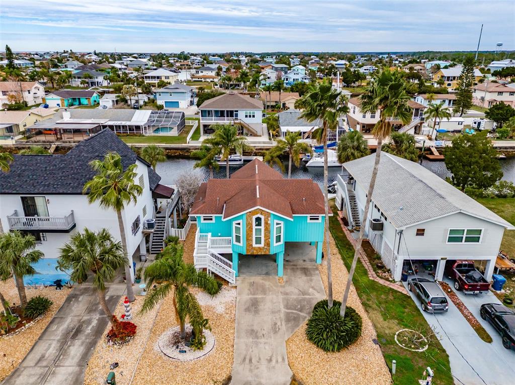4021 Casa Court Hernando Beach, FL 34607 - Photo 36 of 37 an aerial view of a house with a garden and lake view