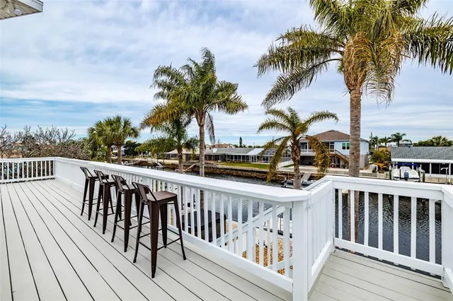 a view of balcony with wooden floor and fence