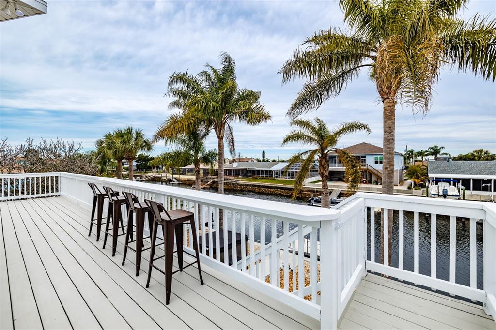 4021 Casa Court Hernando Beach, FL 34607 - Photo 6 of 37 a view of balcony with wooden floor and fence
