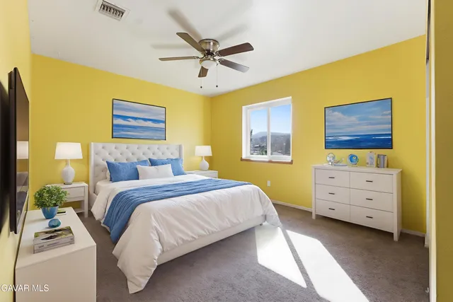 a bedroom with a bed and a dresser