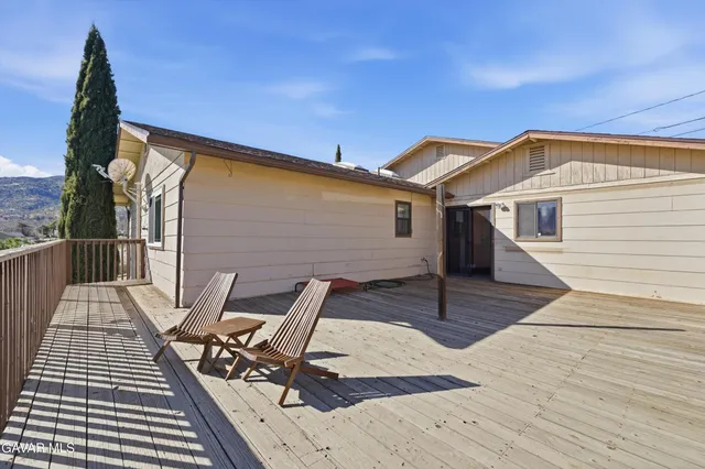 a view of a backyard with table and chairs