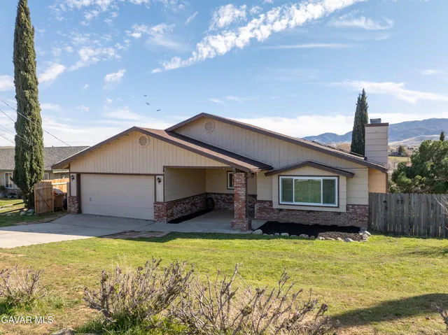 a view of a terrace with a garden and mountain view