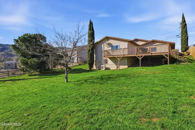 a front view of house with yard and trees
