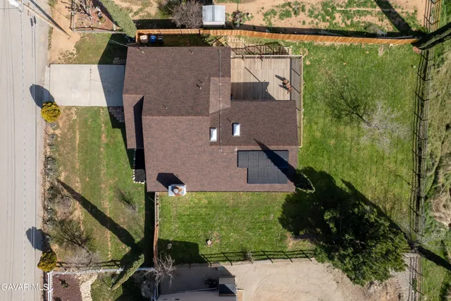 a aerial view of a house with a yard basket ball court and outdoor seating