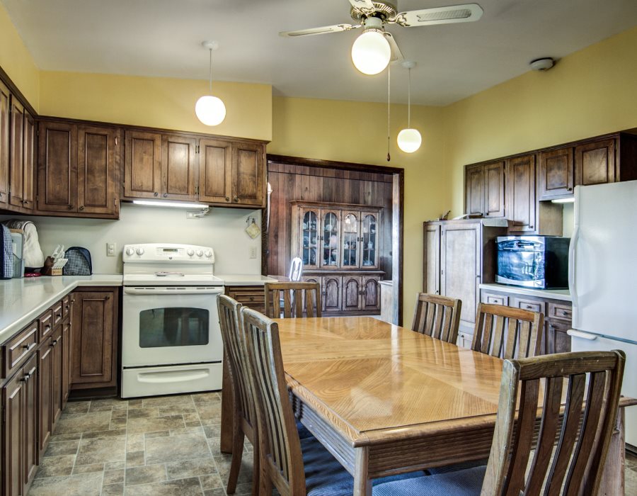 14851 Freeport Road Durand, IL 61024 - Photo 11 of 25 a kitchen with stainless steel appliances granite countertop a sink a stove a refrigerator cabinets and chairs