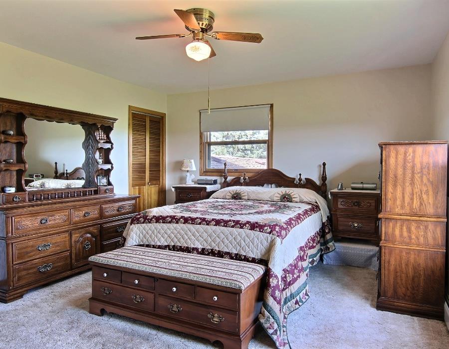 14851 Freeport Road Durand, IL 61024 - Photo 14 of 25 a bedroom with a bed and wooden floor