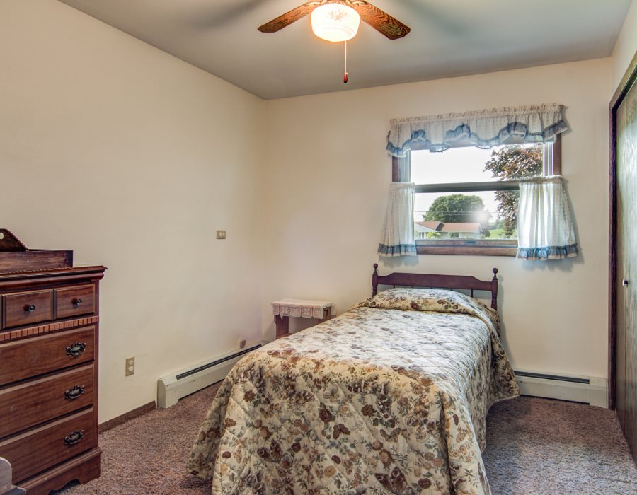 14851 Freeport Road Durand, IL 61024 - Photo 17 of 25 a bedroom with a bed and a chandelier