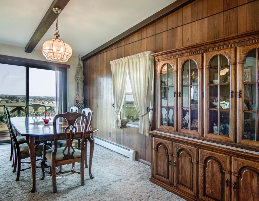 14851 Freeport Road Durand, IL 61024 - Photo 7 of 25 a view of a dining room with furniture a chandelier and wooden floor