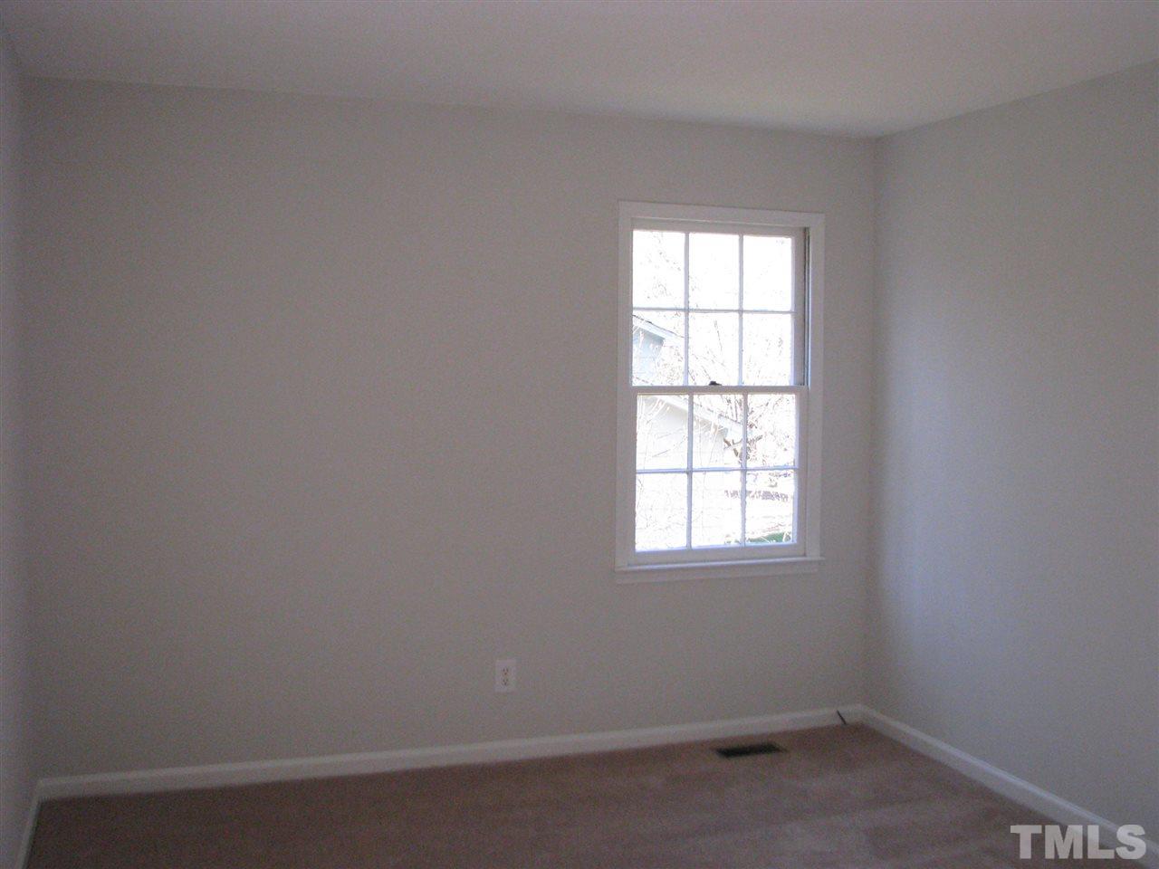 1101 Mockingbird Drive Raleigh, NC 27615 - Photo 13 of 21 an empty room with a window