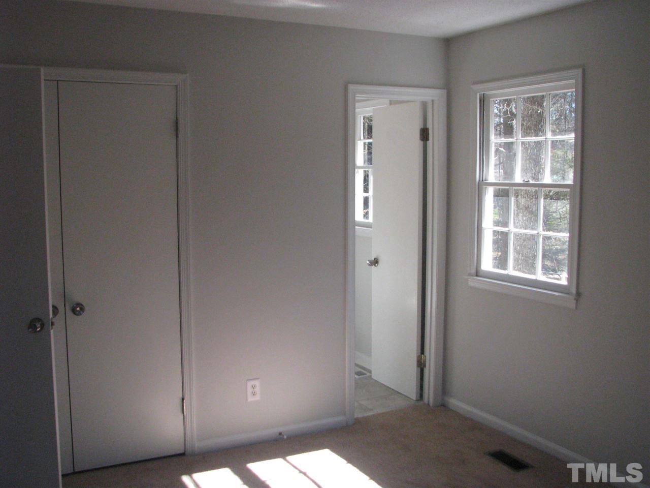 1101 Mockingbird Drive Raleigh, NC 27615 - Photo 15 of 21 a view of an empty room with windows
