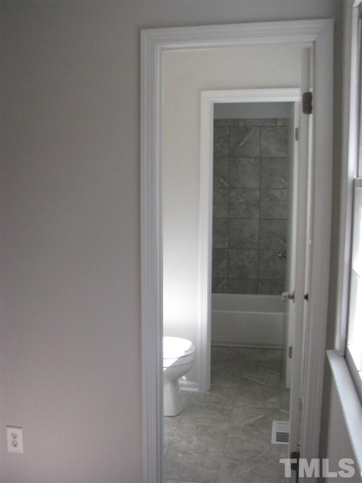 1101 Mockingbird Drive Raleigh, NC 27615 - Photo 16 of 21 a bathroom with a toilet
