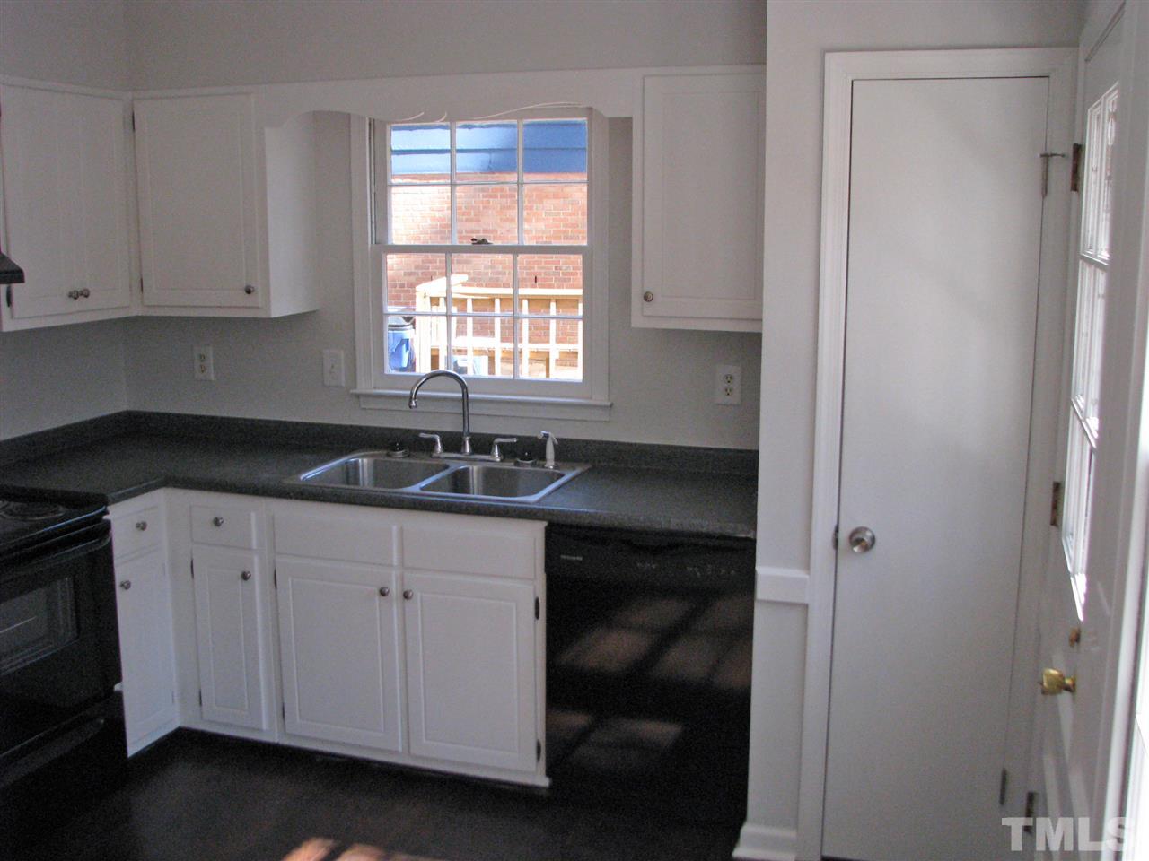 1101 Mockingbird Drive Raleigh, NC 27615 - Photo 5 of 21 a kitchen with a sink and cabinets
