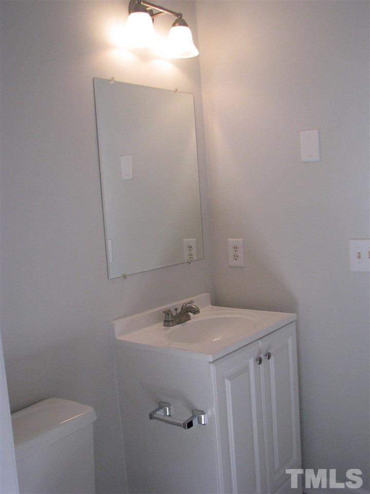 1101 Mockingbird Drive Raleigh, NC 27615 - Photo 8 of 21 a bathroom with a sink and a vanity