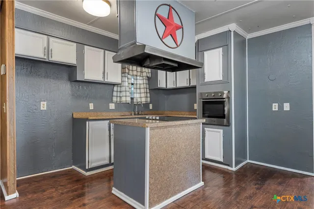 a kitchen with stainless steel appliances granite countertop a stove and a refrigerator