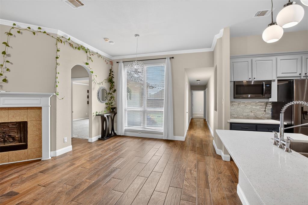 8208 Riversprings Drive Fort Worth, TX 76053 - Photo 12 of 26 a view of a kitchen with a sink wooden floor and a living room