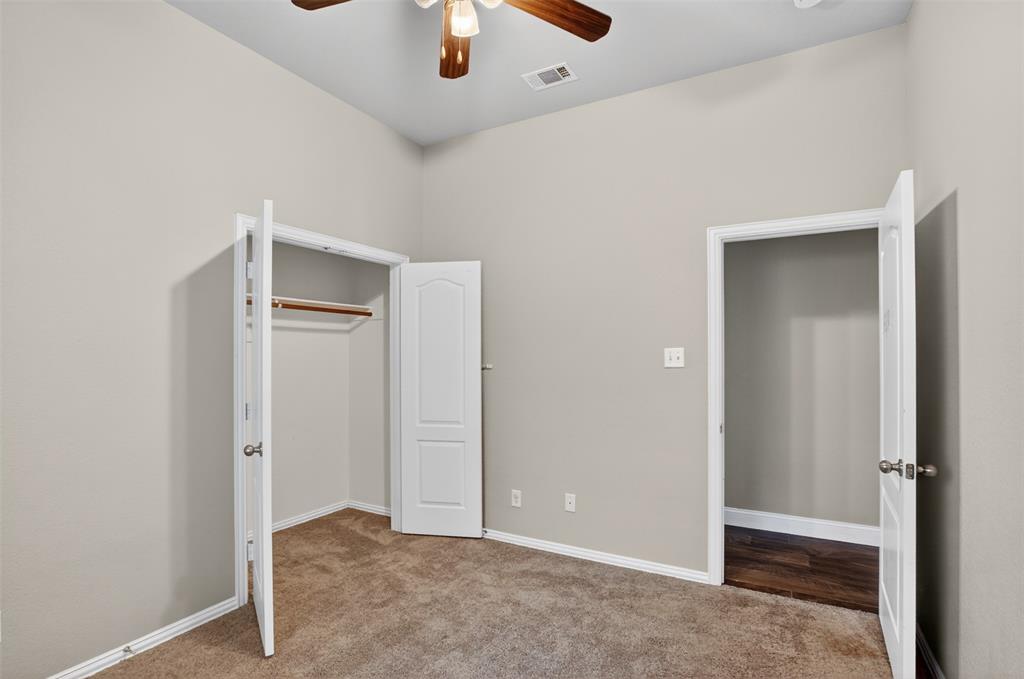 8208 Riversprings Drive Fort Worth, TX 76053 - Photo 19 of 26 an empty room with closet and a chandelier fan