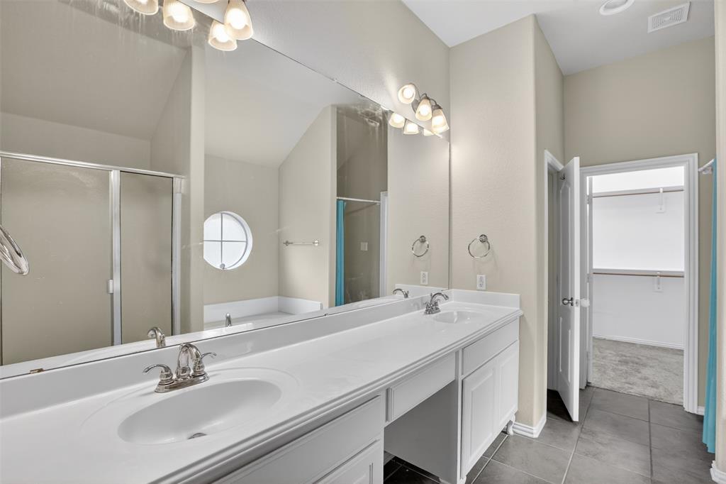 8208 Riversprings Drive Fort Worth, TX 76053 - Photo 21 of 26 a bathroom with a double vanity sink mirror and shower