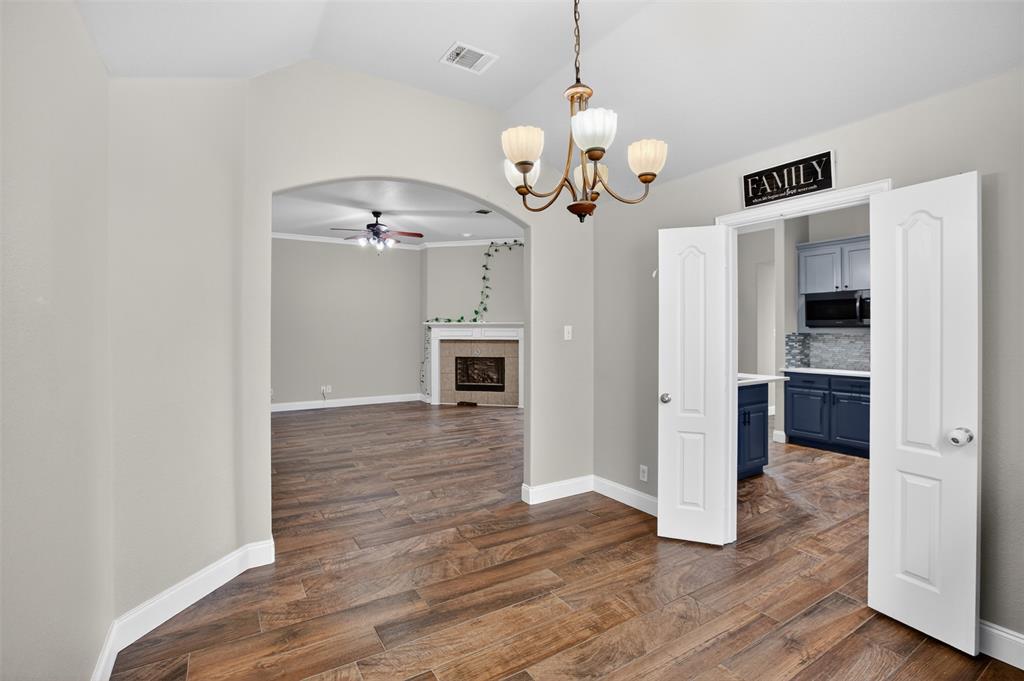 8208 Riversprings Drive Fort Worth, TX 76053 - Photo 3 of 26 a view of a hallway with wooden floor and a kitchen