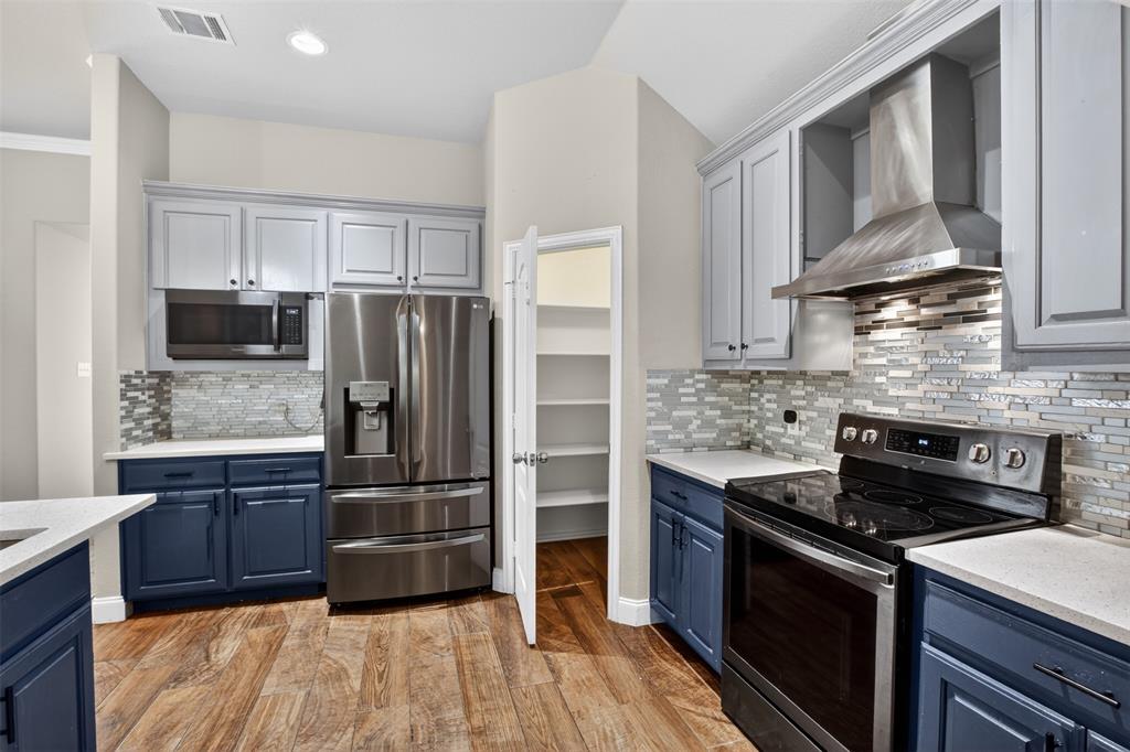 8208 Riversprings Drive Fort Worth, TX 76053 - Photo 4 of 26 a kitchen with granite countertop a refrigerator stove and microwave