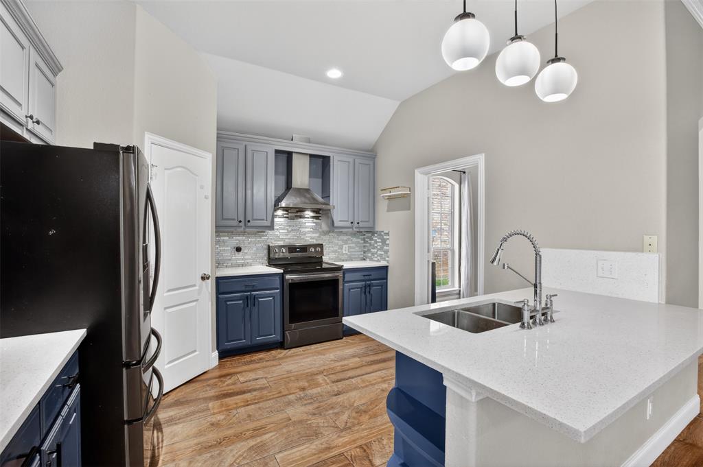 8208 Riversprings Drive Fort Worth, TX 76053 - Photo 5 of 26 a kitchen with stainless steel appliances granite countertop a sink refrigerator and cabinets