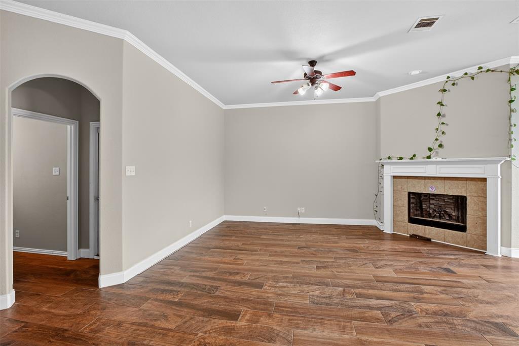 8208 Riversprings Drive Fort Worth, TX 76053 - Photo 9 of 26 wooden floor in an empty room with a fireplace