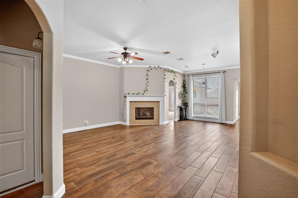 8208 Riversprings Drive Fort Worth, TX 76053 - Photo 10 of 26 a view of a livingroom with wooden floor and a fireplace