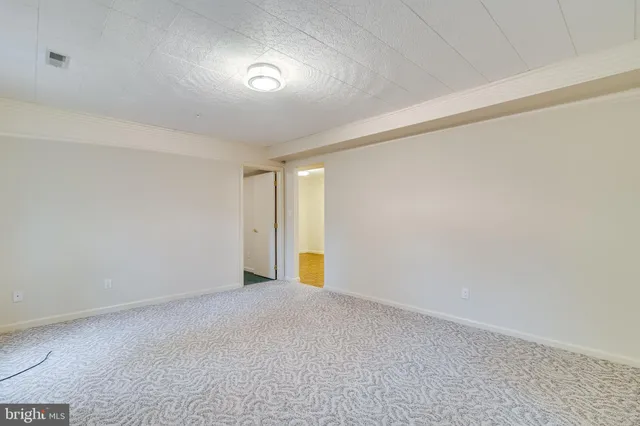 an empty room with windows and closet