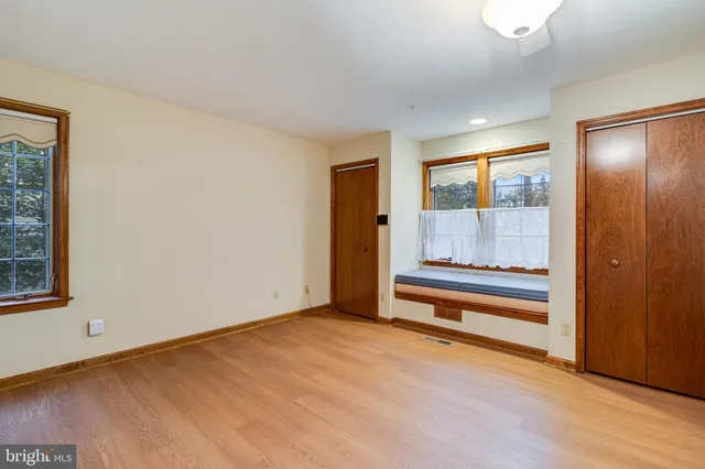 a view of room with window and ceiling fan