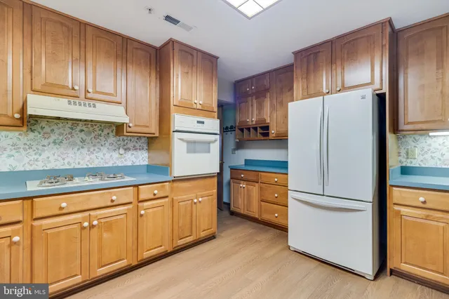 a kitchen with granite countertop stainless steel appliances and refrigerator