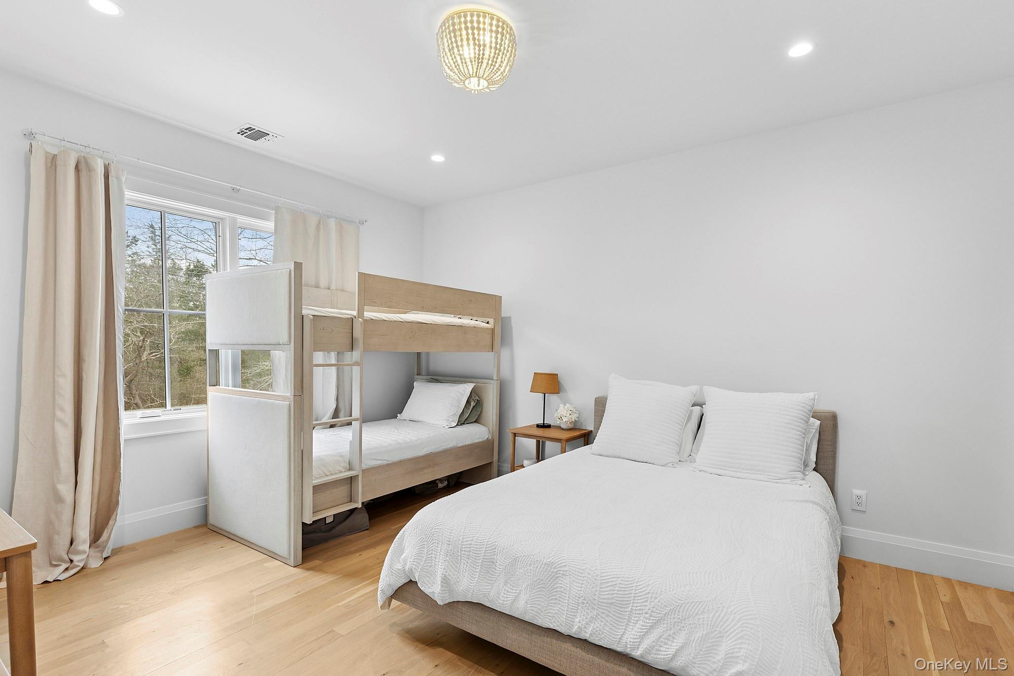 8 Sweetgrass Road Westhampton, NY 11977 - Photo 17 of 20 a bedroom with 2 bed and a large window