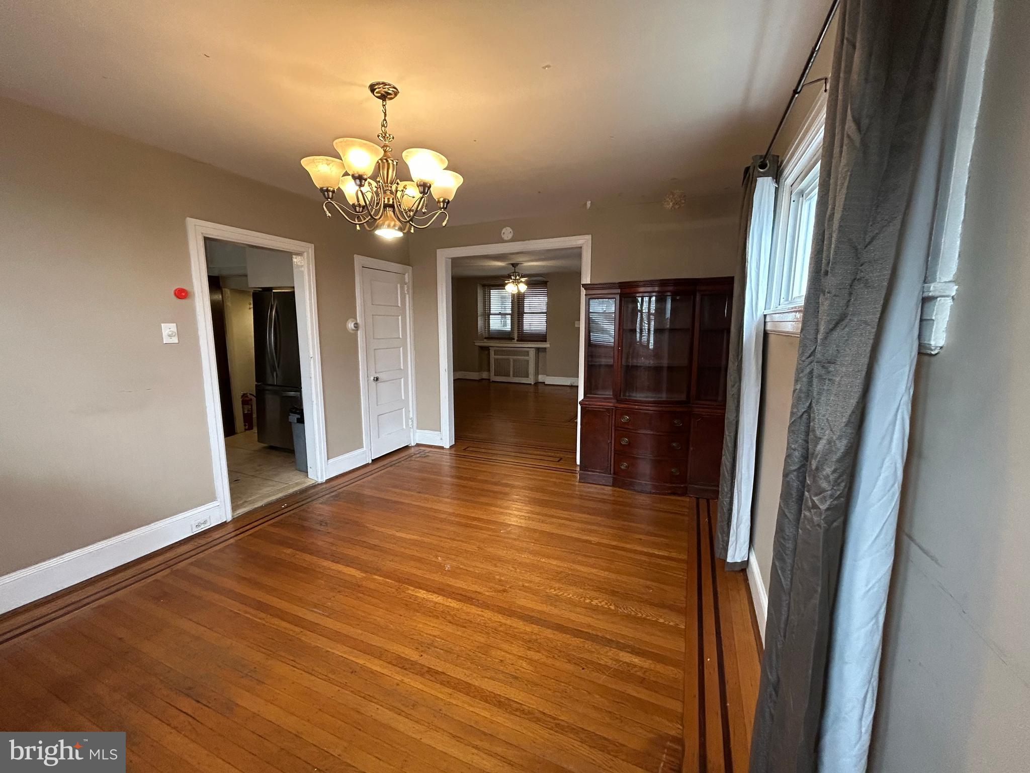 7502 Parkview Road Upper Darby, PA 19082 - Photo 12 of 63 a view of a hallway with wooden floor and a chandelier