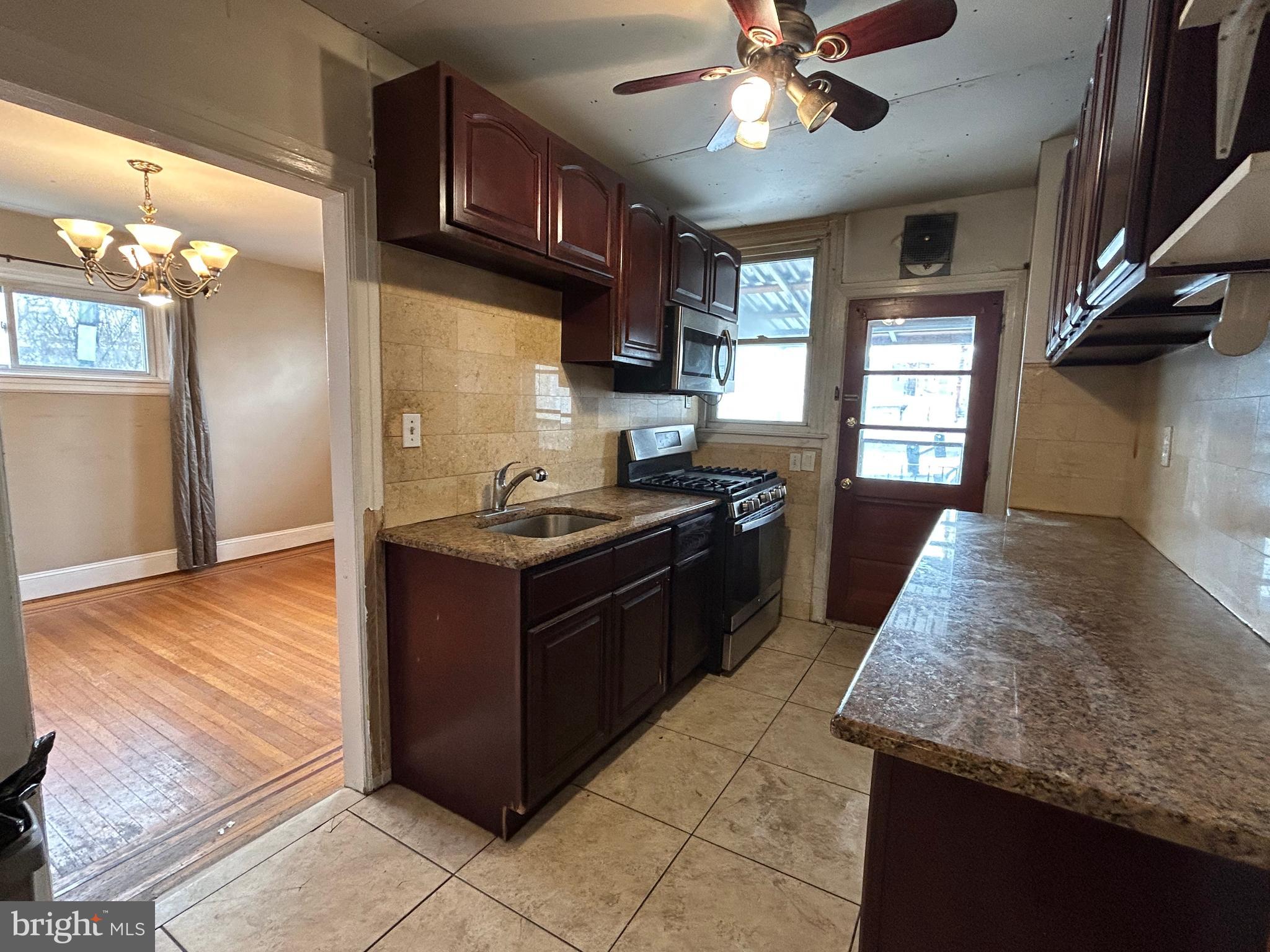 7502 Parkview Road Upper Darby, PA 19082 - Photo 13 of 63 a kitchen with granite countertop stainless steel appliances and wooden cabinets