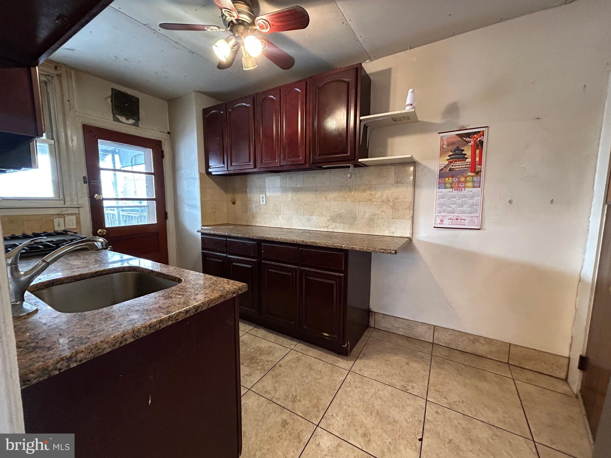 7502 Parkview Road Upper Darby, PA 19082 - Photo 14 of 63 a kitchen with stainless steel appliances granite countertop a sink and a stove