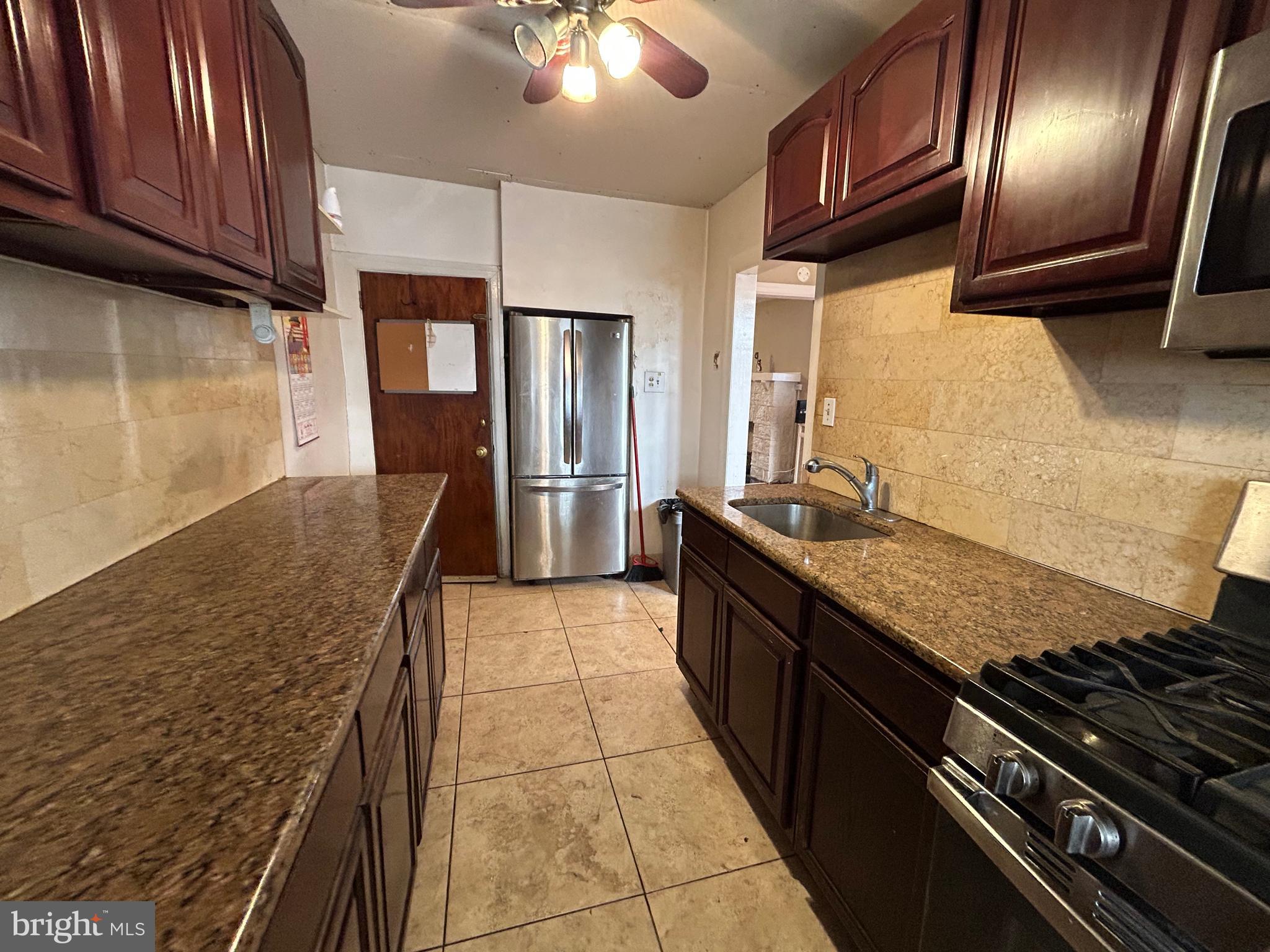 7502 Parkview Road Upper Darby, PA 19082 - Photo 16 of 63 a kitchen with granite countertop stainless steel appliances and wooden cabinets