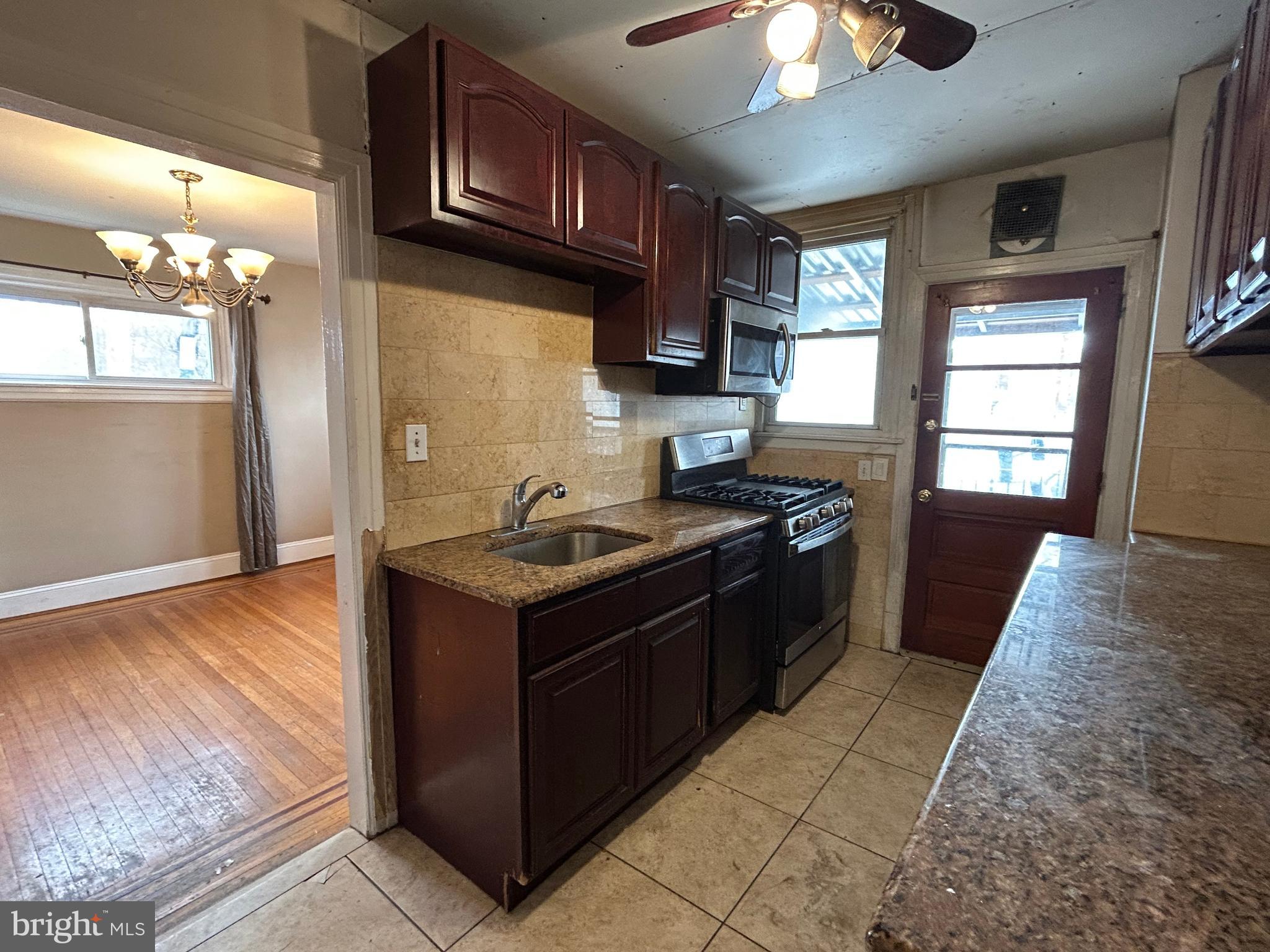 7502 Parkview Road Upper Darby, PA 19082 - Photo 18 of 63 a kitchen with a stove and a refrigerator