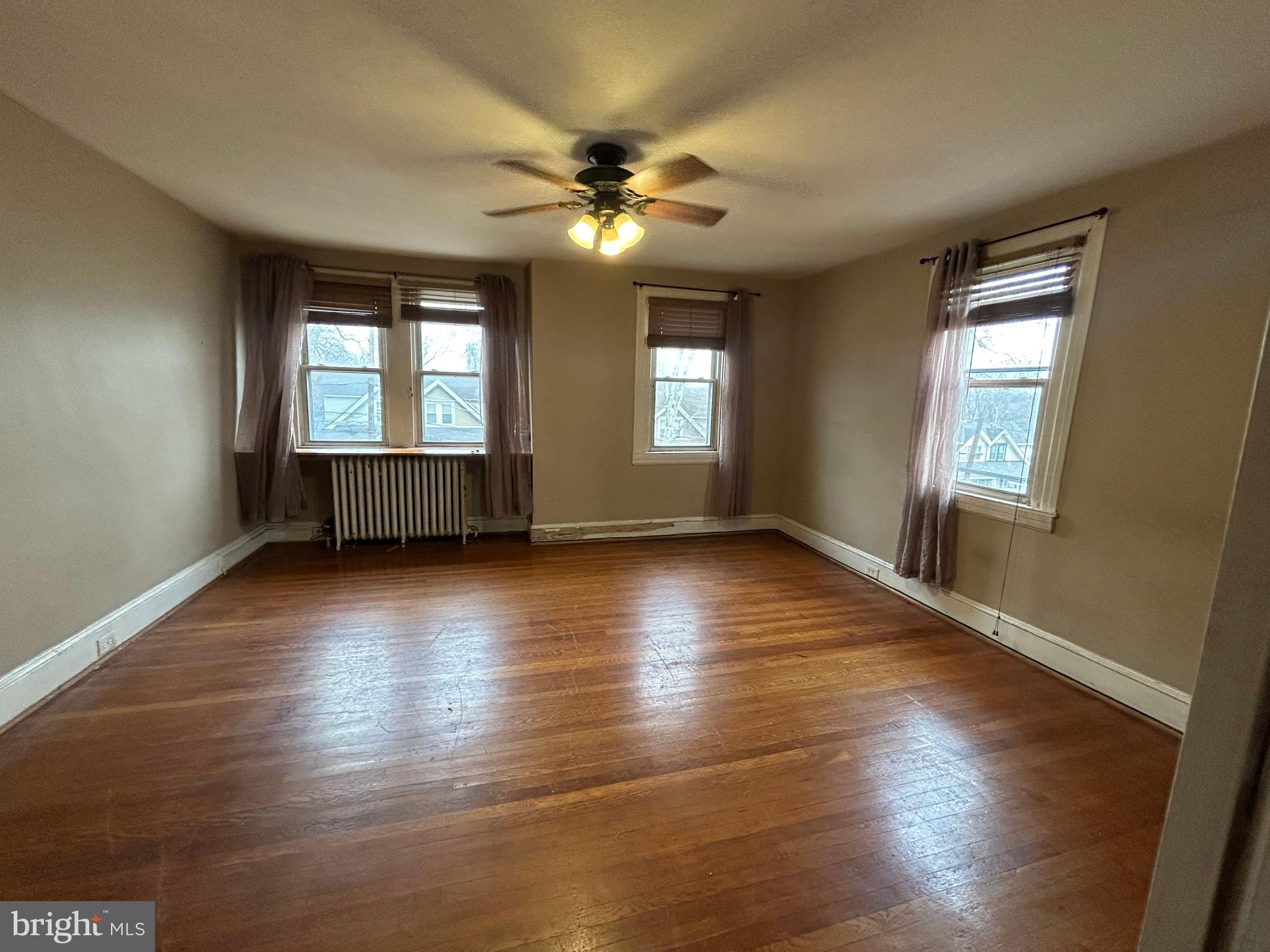 7502 Parkview Road Upper Darby, PA 19082 - Photo 20 of 63 a view of an empty room with wooden floor and a window