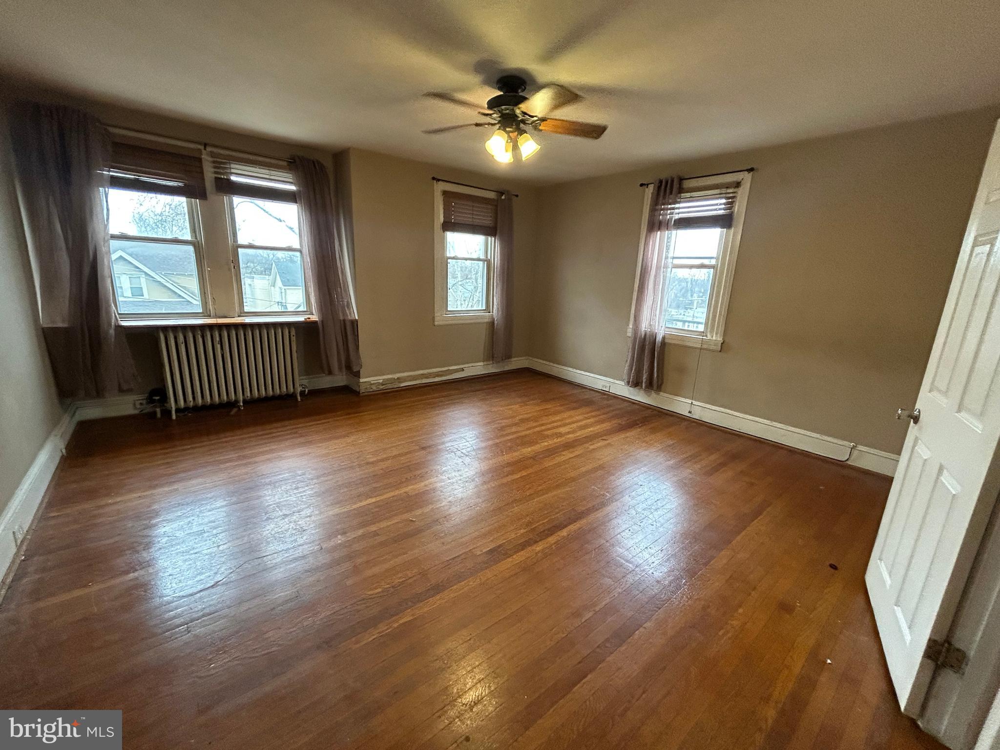 7502 Parkview Road Upper Darby, PA 19082 - Photo 21 of 63 a view of an empty room with wooden floor and a window
